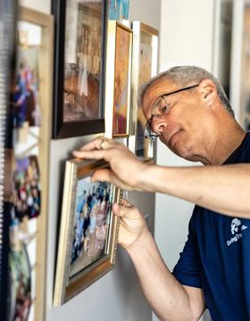 Man hanging a picture frame
